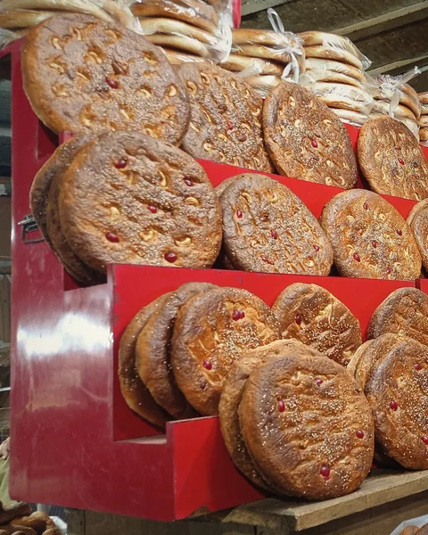 Trays of fresh bakarkhani stacked on a bakery counter.